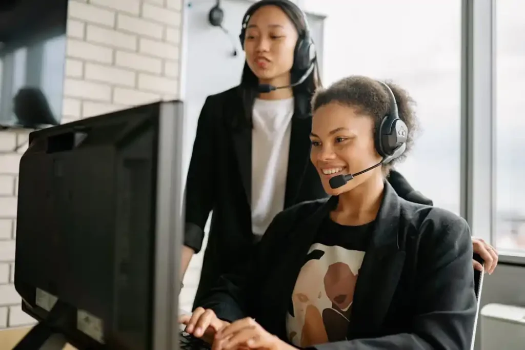 Cold Calling Agents assisting each other in office