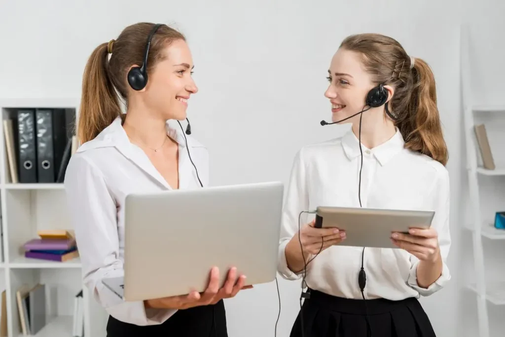 Two call center agents discussing sales strategy