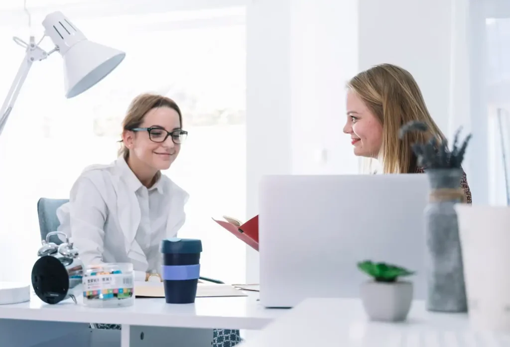 Friendly business meeting discussing cold calling strategy